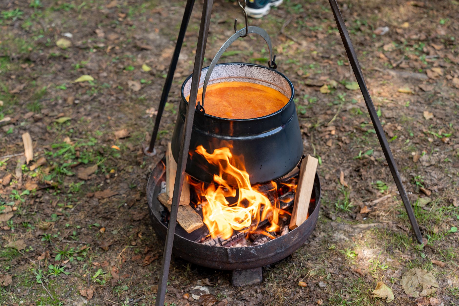 A black pot over a campfire cooking food outdoors in Garešnica, Croatia.